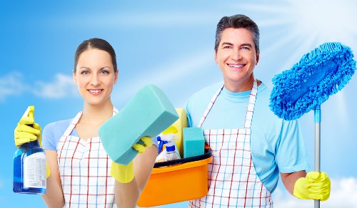 Technician using steam carpet cleaning equipment